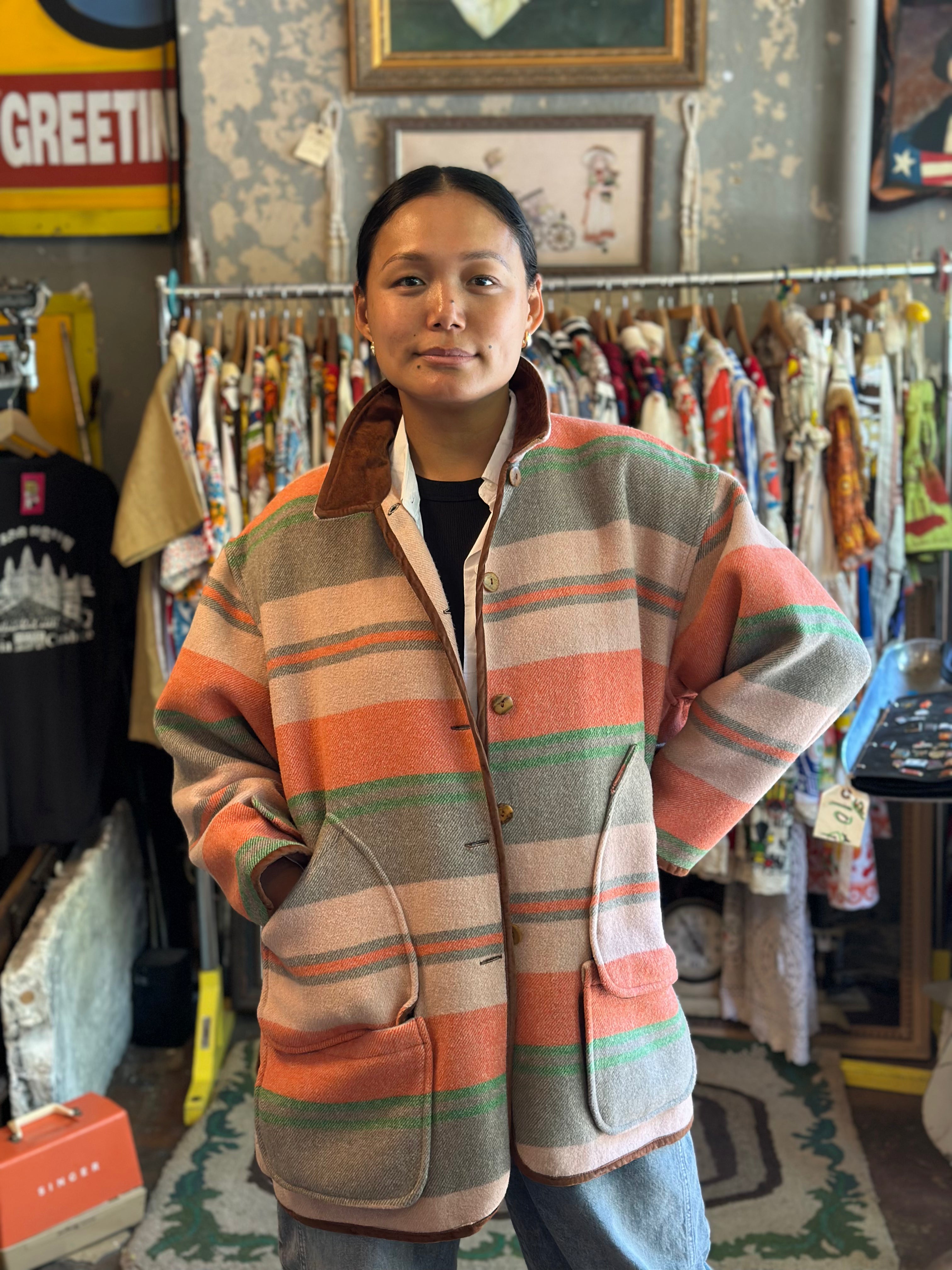 Person wearing a colorful jacket in a vintage store setting