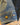 Close-up of a blue denim jacket with two buttons on a blurred background