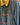 Blue denim jacket with yellow corduroy collar and toggle buttons on a hanger.