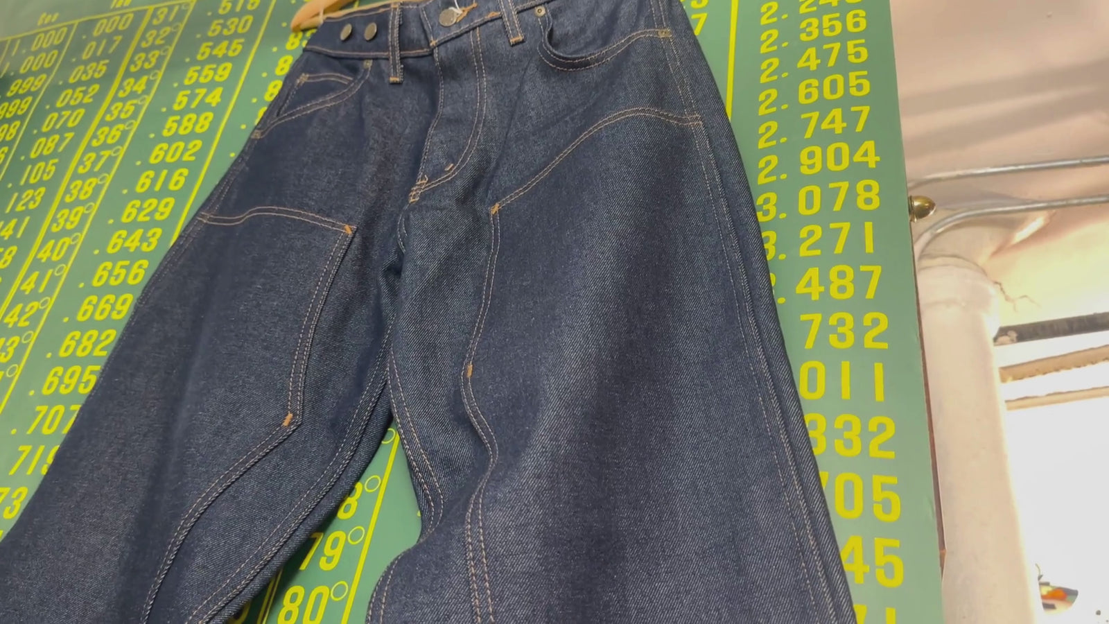 Video of blue jeans displayed then moving throughout the Grand Leaners store