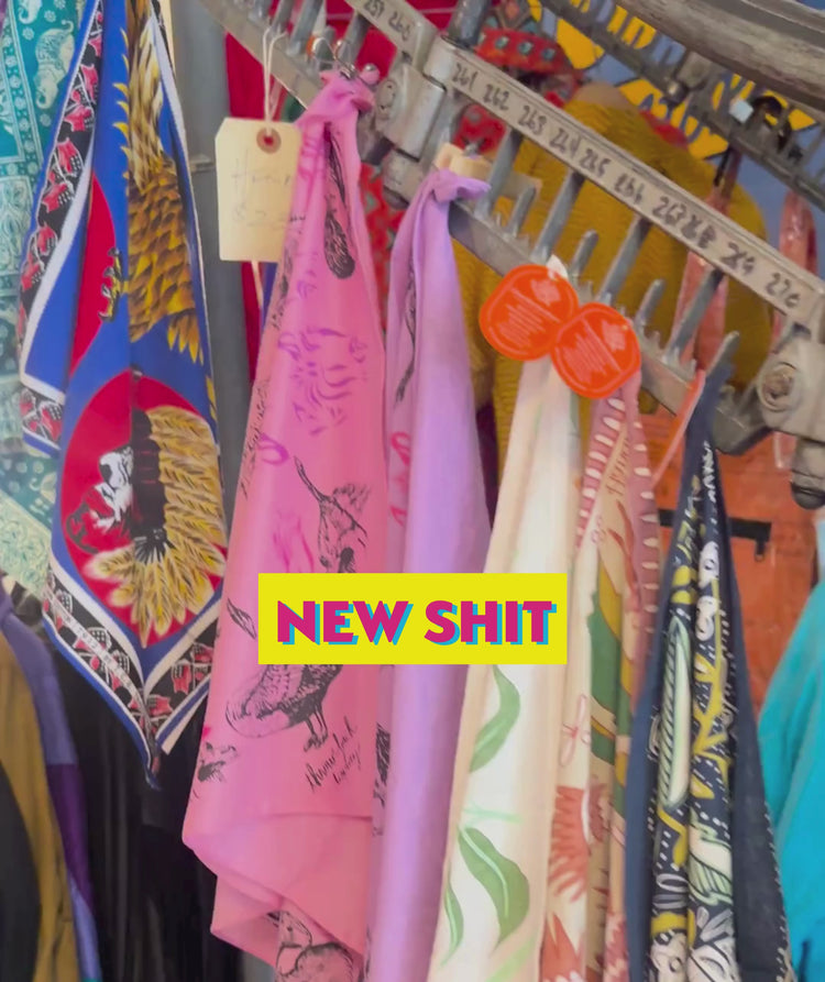 Grand Leaners new shit category video banner featuring scarves on conveyor belt inside the store